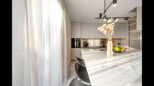a kitchen with a large marble table and chairs at Villa 8 - luxury roof top pools in Srima