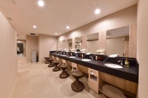 a bathroom with a row of sinks and mirrors at Vessel Hotel Campana Nagoya in Nagoya