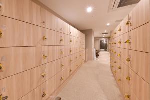 a row of lockers in a gym with yellow pins at Vessel Hotel Campana Nagoya in Nagoya