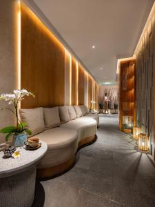 a living room with a white couch in a room at GRAND HOTEL du LAC Hanoi in Hanoi