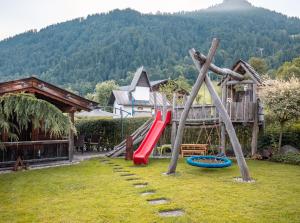 a playground with a slide in a yard at Bauernhof Kodahof – Familie Rabl in Itter