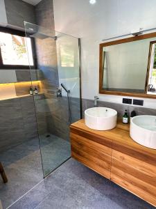 a bathroom with a sink and a glass shower at VILLA CAMILLE - SEAVIEW - 4 Bedrooms in Koh Samui 