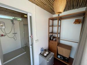 a bathroom with a shower and a glass shower stall at Nice Sea Resort in Srithanu