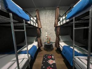 a room with two bunk beds and a table at Mountain View Party Hostel in Ban Chong Phli
