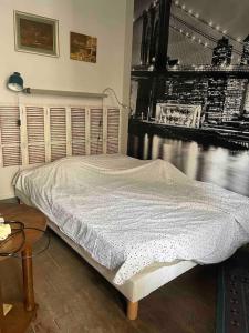 a bedroom with a bed and a table and a window at Cosy Nest in Montmartre in Paris