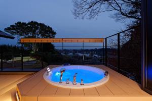 a hot tub on the deck of a house at TOKIWA M-GARDEN in Mito