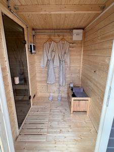 a sauna with two dresses hanging on the wall at La bergerie in Saint-Apollinaire-de-Rias