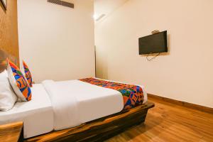 a bedroom with a bed and a flat screen tv at FabHotel Sallow Grand in Amritsar