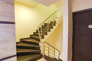 a staircase in a building with a stair case at FabHotel Sallow Grand in Amritsar