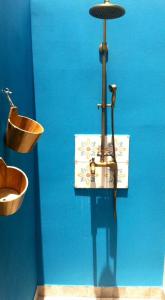 a blue bathroom with a sink and a bowl at La Villa Bleue - Villa d'architecte - Jacuzzi in Saint-Paul