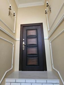 a black door in a room with a stair case at Iconic House Plovdiv in Plovdiv