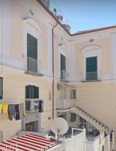 a building with stairs and clothes hanging on the balconies at CASA VACANZE DI MARILENA in Vietri sul Mare