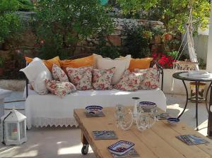 a white couch with many pillows on a table at Trullo Donna Caterina in Ceglie Messapica
