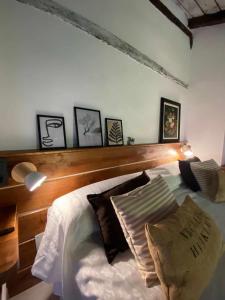 a bedroom with a white bed with a wooden headboard at Las Casas de Quintanilla 3 in Quintanilla las Torres