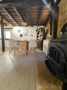 a living room with a fireplace and a table and chairs at Las Casas de Quintanilla 3 in Quintanilla las Torres