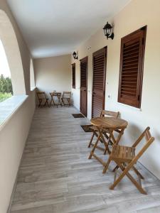 a row of chairs and tables on a balcony at Villa Blue Paradise Relax con piscina a pochi minuti da Cagliari e dal mare in Cagliari
