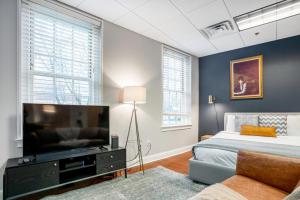 a bedroom with a bed and a flat screen tv at Downtown Studio w AC nr N Station TD Garden BOS-211 in Boston