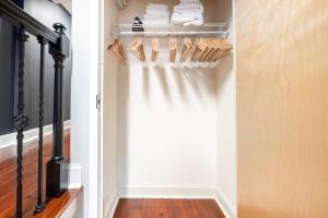 a walk in closet with white curtains and wooden floors at Downtown Studio w AC nr N Station TD Garden BOS-211 in Boston