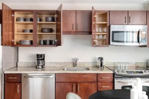 a kitchen with wooden cabinets and stainless steel appliances at Foggy Bottom 1br w wd pool gym nr Georgetown WDC-652 in Washington