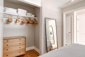 a bedroom with a dresser and a mirror at Foggy Bottom 1br w wd pool gym nr Georgetown WDC-652 in Washington +35 photos