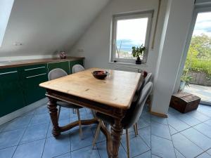 a kitchen with a wooden table and some chairs at Zum schönen Ausblick in Weißenthurm