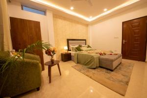 a bedroom with a bed and a couch and a chair at Perfectstayz Value Homes Mussoorie 120 meters uphill in Mussoorie +91 photos