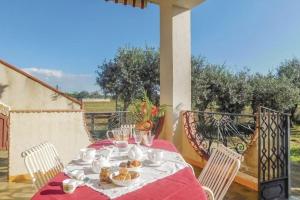 une table avec une assiette de nourriture sur une terrasse couverte dans l'établissement Villa in campagna vicina al mare Bonerelax, à Menfi