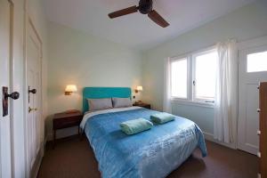 sypialnia z niebieskim łóżkiem z 2 poduszkami w obiekcie Wenvoe - Historic retreat w mieście Lithgow