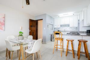 a kitchen and dining room with a table and chairs at Laguna La Crete 6 in Uvongo Beach