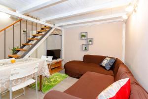 a living room with a couch and a staircase at Sicily Loft Catania few min from sea - Happy Rentals in Catania