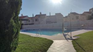 a swimming pool in front of a house at Beautiful duplex in Salobreña in Salobreña