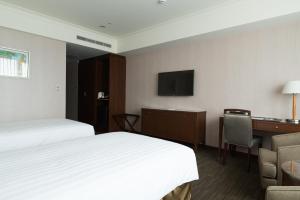 Postel nebo postele na pokoji v ubytování Fushin Hotel Taipei