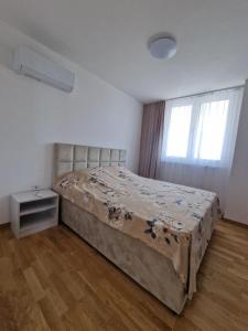 a bedroom with a bed in a room with a window at PETKOV5KI.LuxuryApartments in Skopje