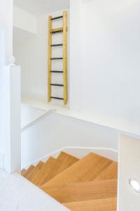 a ladder on a shelf in a room with wooden floors at Hidden Gem in Chiswick, Stylish 1 Bedroom House in London
