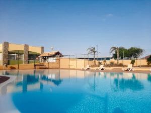 a large swimming pool in front of a building at Casa Adele terraza del mar in Corralejo