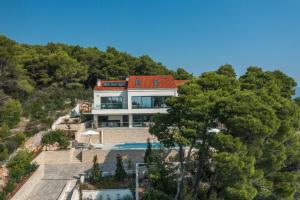 an aerial view of a house with trees at Stylish Lumbarda Villa Sleeps 10 with Private Pool in Lumbarda