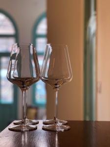 two wine glasses sitting on top of a table at Talpiot Oasis-Louis in Haifa