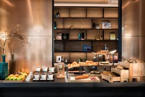a bakery with many different types of food on display at Adina Apartment Hotel Frankfurt Westend in Frankfurt/Main
