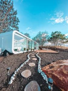 a gravel path in front of a rv at Modern Off Grid Tiny Home! in Haleiwa