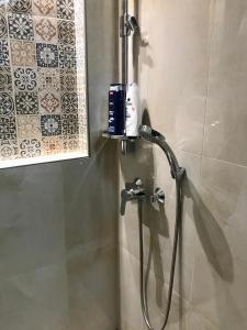 La salle de bains est pourvue d'une douche avec un pommeau de douche. dans l'établissement Deviza Apartments, à Budapest