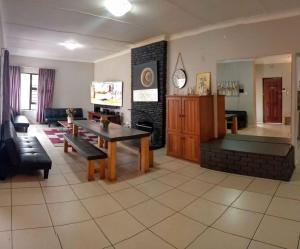 a living room with a table and a couch at GALAXY BOSTON BELLVILLE in Cape Town