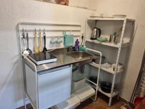 a small kitchen with a sink and a refrigerator at Atelier apartment in Krasica