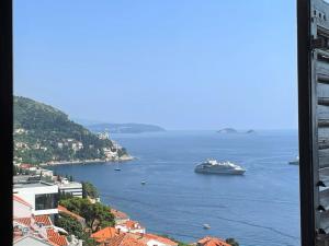 a cruise ship in a large body of water at Dalmatins MillionDollar sea view in Dubrovnik