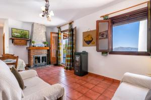 a living room with a couch and a fireplace at Casa Jose Capileira - Alpujarra in Capileira