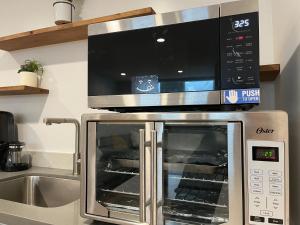 a microwave above a oven in a kitchen at Cheerful 3Br2Ba and a living room Sunny patio in San Francisco