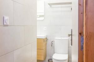 a white bathroom with a toilet and a sink at Appartement Vieux-Port de Marseille - Opéra - 3 étoiles in Marseille +5 photos