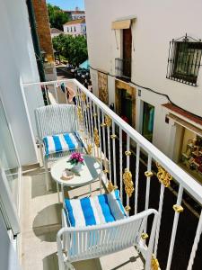 a balcony with two chairs and a table at Mare Apartments Marbella in Marbella