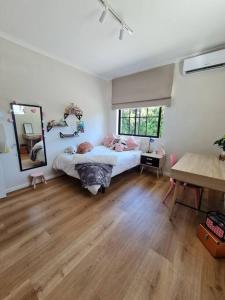a bedroom with a bed and a large mirror at Holiday home in Fresnay-NO load shedding in a secure estate in Cape Town