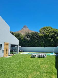 a house with a yard with a swimming pool at Holiday home in Fresnay-NO load shedding in a secure estate in Cape Town