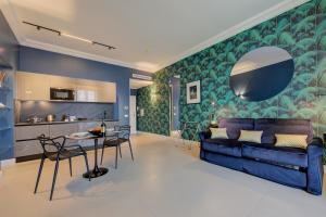 a living room with a blue couch and a table at Boutique Central Apartments- Happy Rentals in Sanremo